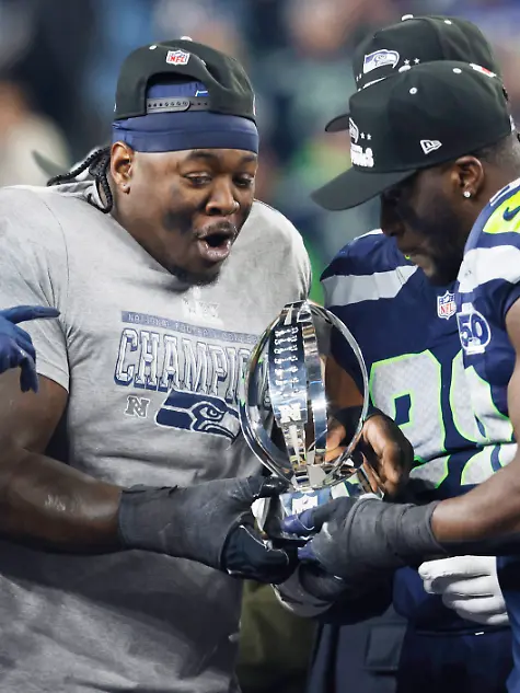 Seattle-Seahawk-players-hold-the-George-Halas-Trophy-after-the-Seahawks-defeated-the-Los-Angeles-Rams-31-27-to-win-their-NFL-Conference-Championship-game-at-Lumen-Field-in-Seattle-Washington-on-Sunday-January-25-2026-The-Seahawks-advance-to-play-the-New-England-Patriots-in-the-Super-Bowl-on-February-8-2026