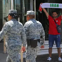 Members-of-the-National-Guard-patrol-outside-the-hotel-where-Iran-s-national-football-team-is-staying-as-a-fan-holds-up-a-scarf-while-waiting-for-the-players-to-depart-for-a-training-session-at-Estadio-Caliente-ahead-of-the-2026-FIFA-World-Cup-in-Tijuana-Mexico-June-9-2026