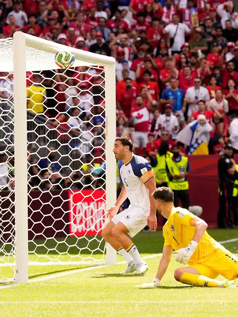 Canada-s-Richie-Laryea-22-watches-as-his-shot-at-goal-is-cleared-away-off-the-crossbar-by-Bosnia-s-Sead-Kolasinac-rear-the-second-half-of-the-World-Cup-Group-B-soccer-match-between-Canada-and-Bosnia-Friday-June-12-2026-in-Toronto