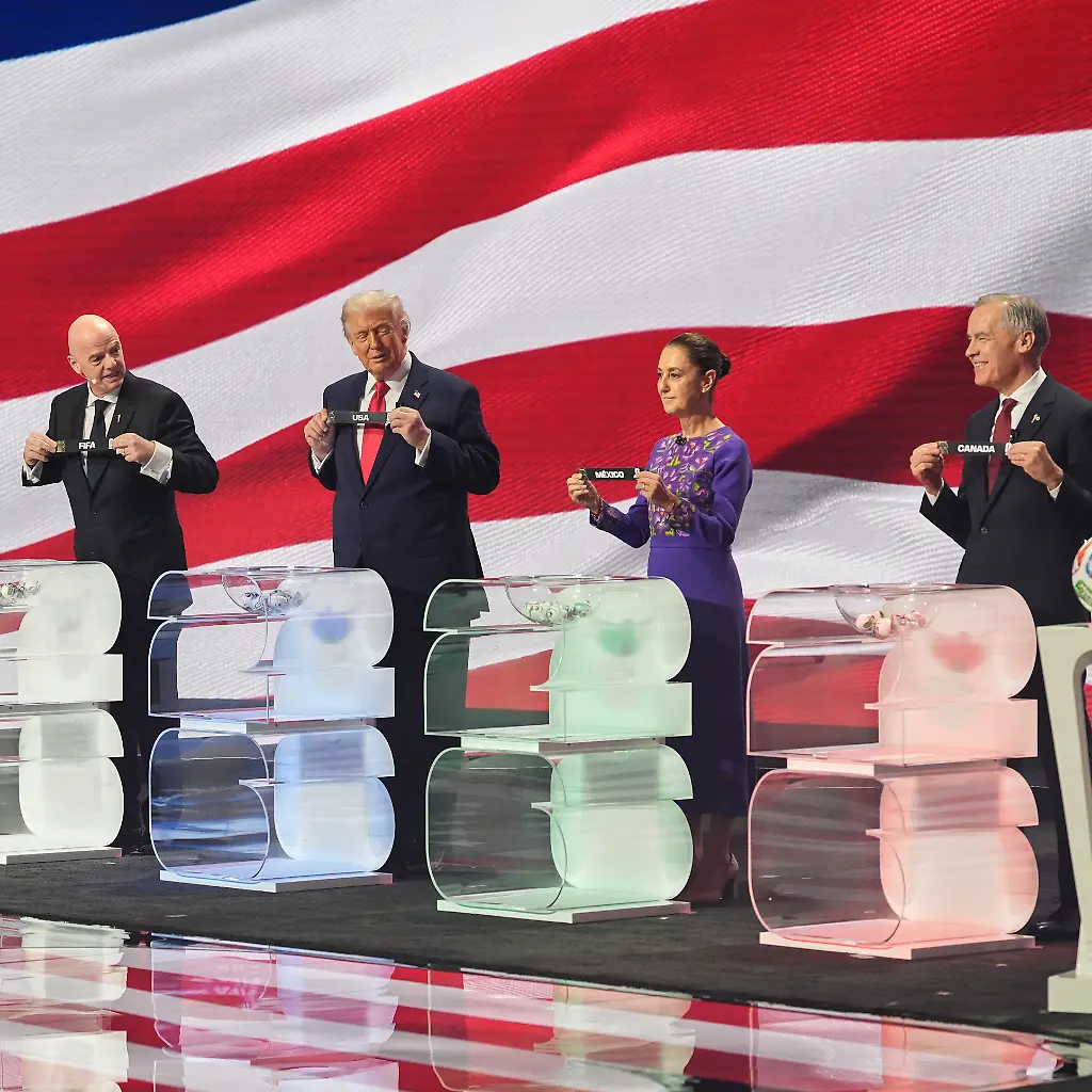 Canadian-Prime-Minister-Mark-Carney-Mexican-President-Claudia-Sheinbaum-President-Donald-Trump-and-FIFA-President-Gianni-Infantino-hold-up-country-names-during-the-draw-for-the-2026-soccer-World-Cup-at-the-Kennedy-Center-in-Washington-Friday-Dec-5-2025