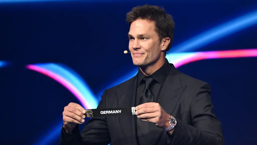 Former-NFL-player-Tom-Brady-holds-up-Germany-after-drawing-from-a-pot-during-the-draw-for-the-2026-soccer-World-Cup-at-the-Kennedy-Center-in-Washington-Friday-Dec-5-2025