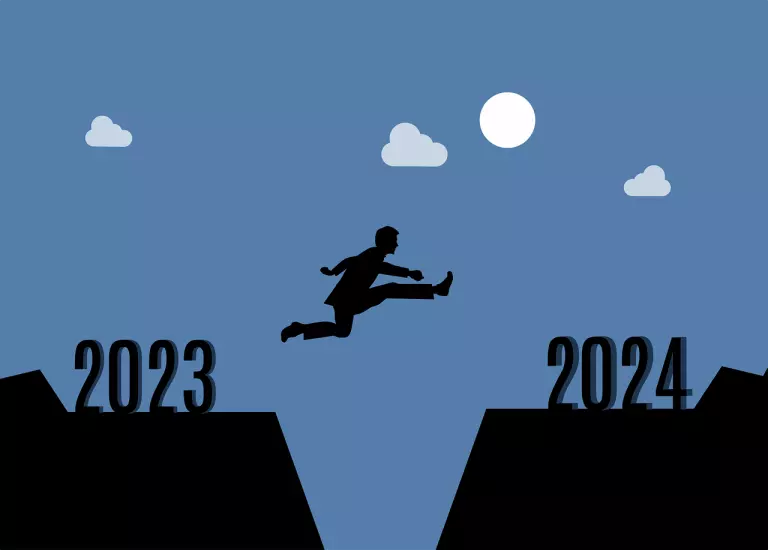 Ein Mann wird gezeigt, wie er vom Jahr 2023 ins Jahr 2024 springt. In diesem Artikel erklären wir alles über Webdesign Trends 2024
